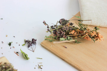 dry herbal tea on a wooden board next to a linen tablecloth, tea from the herb St. John's wort and...