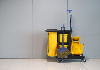 Closeup of janitorial, cleaning equipment and tools for floor cleaning with wall background. 