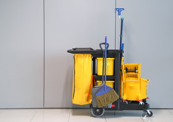 Closeup of janitorial, cleaning equipment and tools for floor cleaning with wall background at the...