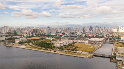 Fototapeta na wymiar Manila city in the morning, view from above. Panorama of a large port city. City with modern buildings and skyscrapers. Manila, the capital of the Philippines. Asian metropolis.