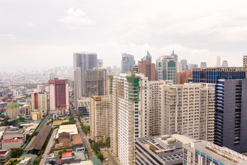 Fototapeta premium Modern city. The city of Manila, the capital of the Philippines. Modern metropolis in the morning, top view. Modern buildings in the city center.