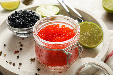 Appetizing composition with caviar and citrus on grey table, close up