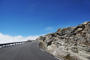 Travel to Norway, car asphalt road goes uphill over a cliff