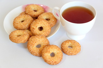 A variety of shaped cookies. White cup of tea. Morning is sweet. Tea ceremony.
