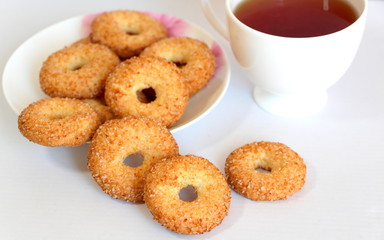 A variety of shaped cookies. White cup of tea. Morning is sweet. Tea ceremony.