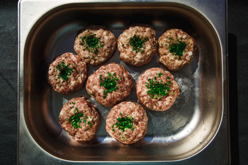 Meat products: cutlets, stuffed cabbage, meatballs in bacon. Fresh appetizing meat store products in metal trays