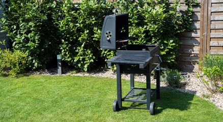 Grill with prepared charcoal for grilling outdoors on backyard