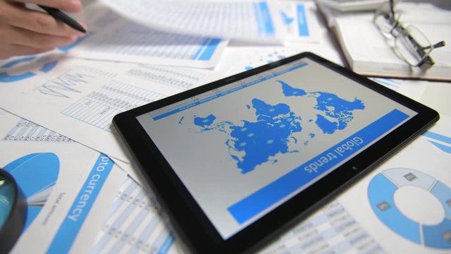 Businessman working with tablet pc, calculating, reading and writing reports. Office employee, table closeup. Business financial accounting concept.