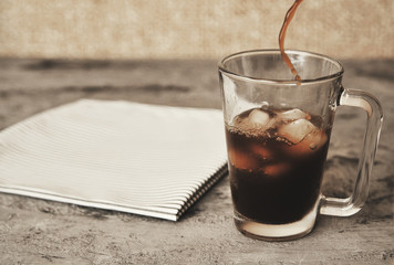Iced coffee on stone background. Summer cold drink.