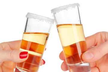 Two hands clinking glasses with shot cocktail isolated on white