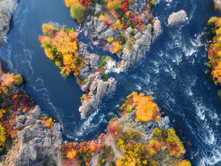 aerial (bird's-eye) view of colorful forest, blue river and rocks. Drone shot. natural beautiful autumn landscape