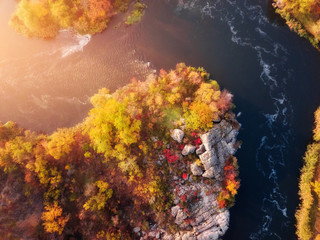 Fototapeta na wymiar aerial (bird's-eye) view of colorful forest, blue river and rocks. Drone shot. natural beautiful autumn landscape