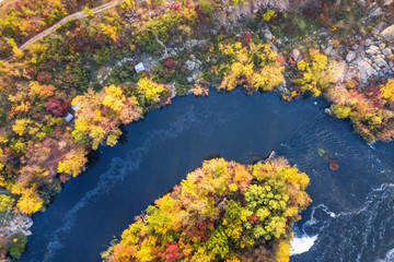 colorful forest, blue river and rocks. natural beautiful autumn landscape (background). drone shot, bird's-eye, aerial view