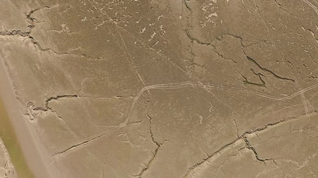 Aerial top down view of the English coast at low tide showing all the ridges and lines in the ocean floor.