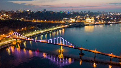Obraz premium aerial night city view, luminous buildings and bridge. Drone shot