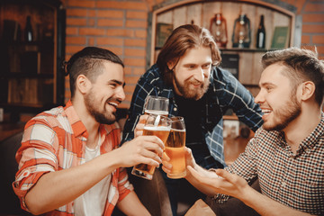 Group of friends enjoying drink pub, tells funny story