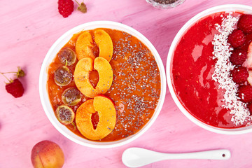 Smoothie bowls. Healthy breakfast bowl on pink background.