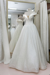 Fototapeta na wymiar Beautiful wedding dress on a mannequin in salon