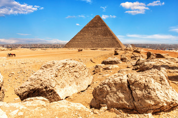 Fototapeta na wymiar The Pyramid of Cheops and stones in the desert of Giza, Egypt