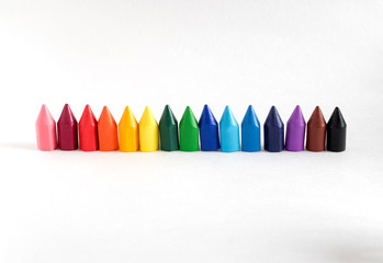 Colored wax pencils for drawing on white paper.