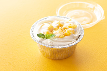 Summer fruit dessert is Mango cheesecake on yellow table background