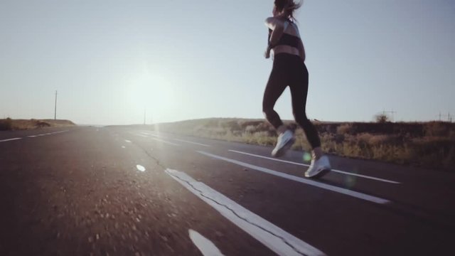 Running woman. Sport jogging in sunny bright light