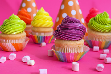 Sweet tasty cupcakes on color background