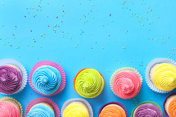 Sweet tasty cupcakes on color background