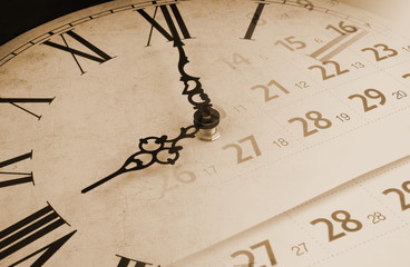 Vintage wall clock and calendar page