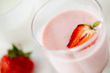 Homemade organic fresh raspberry smoothie with kefir(yogurt,ayran,lassi,milky product) for dieting breakfast in glass on white background close-up.Summer healthy fruit drink.Horizontal orientation