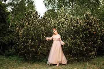 beautiful slender girl with dark hair in gentle elegant dress, fairy-tale princess in the spring flowering garden, the gentle image of the queen, fairy in love