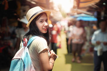 asian woman tourist with backpack travel in market of thailand