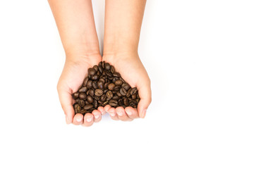 handful of coffee beans in children's hands in the shape of a heart isolated on white background