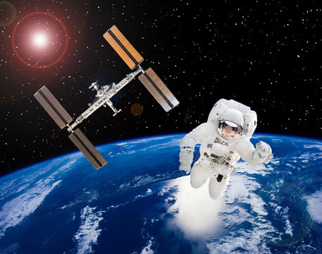 Astronaut above earth and spaceship. The elements of this image furnished by NASA.