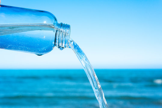 Water Flowing Out Of A Glass Reusable Bottle