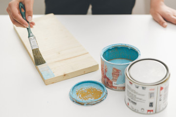 Fototapeta na wymiar painting furniture, close-up hand with brush