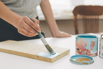 painting furniture, close-up hand with brush