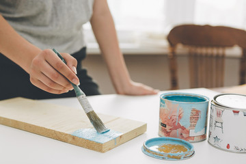 painting furniture, close-up hand with brush