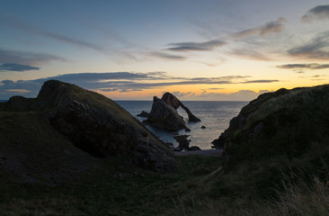 Fototapeta na wymiar Sunrise time by the Bow Fiddle Rock in Scotland