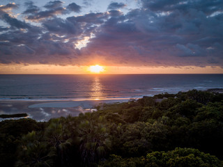 Fototapeta na wymiar Sunrise above the Indian ocean and the forest.