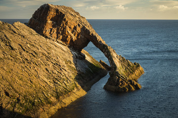 Sunrise time by the Bow Fiddle Rock in Scotland