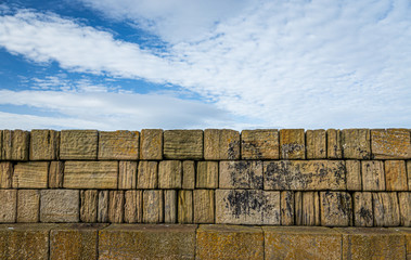Sky and rocky wall of breakwater.
