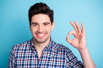 Portrait of charming friendly cute man give feedback attention suggest select give information recommendation advise dressed checkered modern spring clothes isolated on blue background