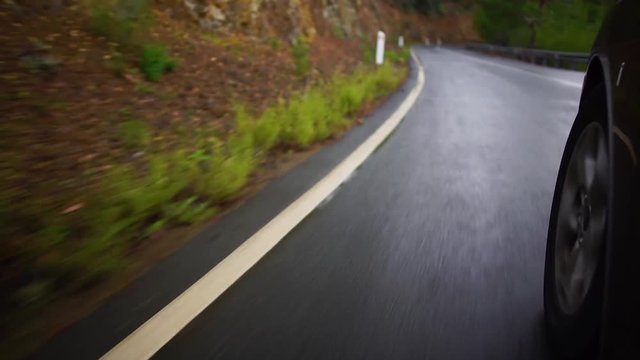 Driving a high-speed car along the markings on a cloudy day in the country with left-hand road traffic. Cyprus.