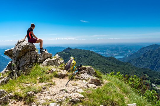 Female hiker on a peak watching the landscape