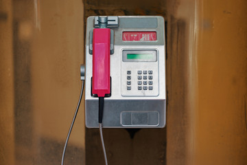 Pink public telephone box outdoor.