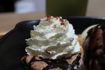 ice cream on the waffle and wipping cream