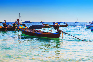 Fototapeta premium Long tailed boat at kho lipe satun Thailand/Fishing boat on the sea and blue sky background at kho lipe satun Thailand/Tropical beach kho lipe satun Thailand wooden long tailed boat on the sea/ 