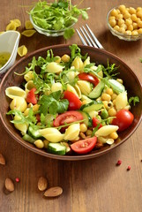 Mediterranean pasta salad with vegetables and chickpeas, vertical 