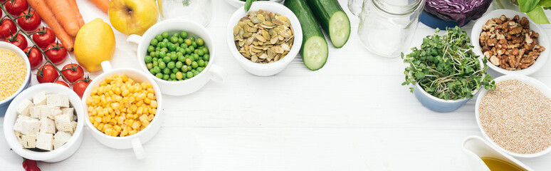 tasty fruits and vegetables near glass jars on wooden white table with copy space, panoramic shot